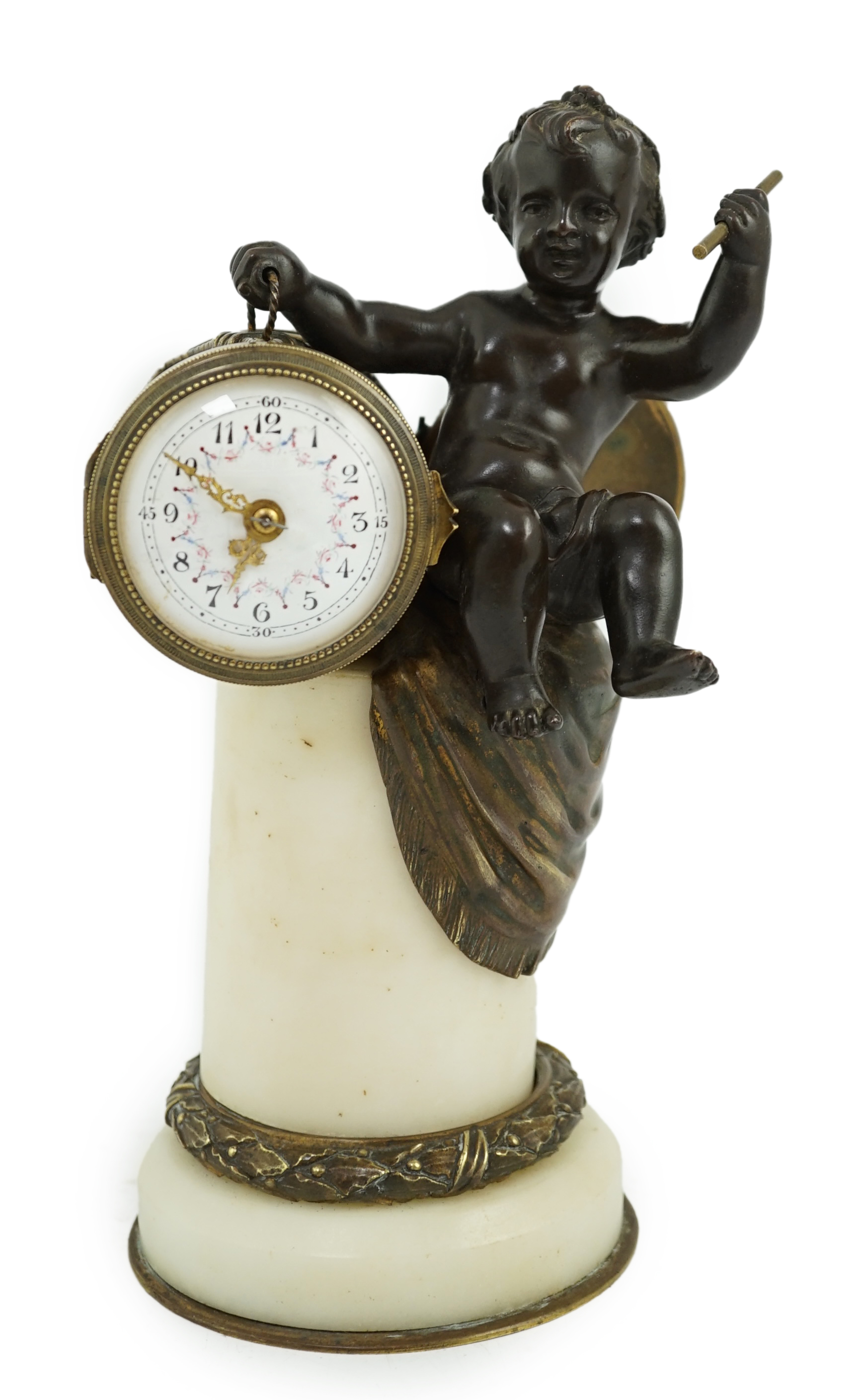 An early 20th century French eight day bronze and ormolu desk timepiece modelled as a putto banging upon a drum, with floral enamelled dial and white marble plinth, 12cm wide, 22.5cm high. Condition - good